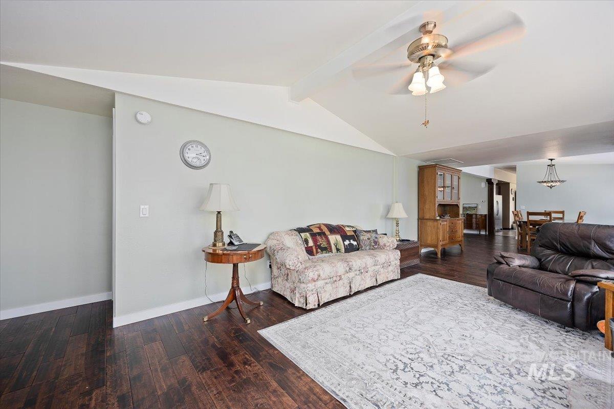 Living room featuring ceiling fan and wood finished floors