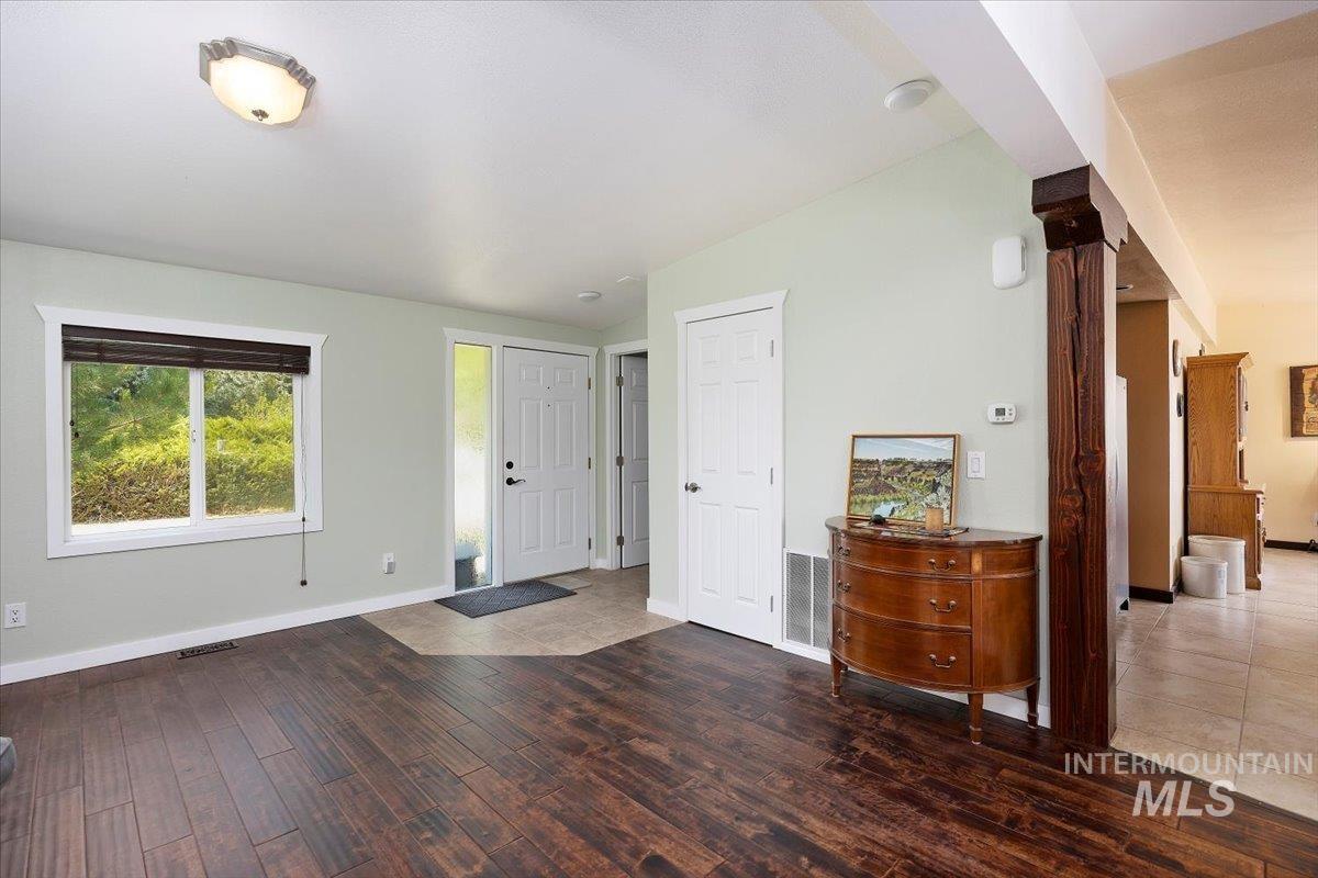 Entryway with wood finished floors and vaulted ceiling