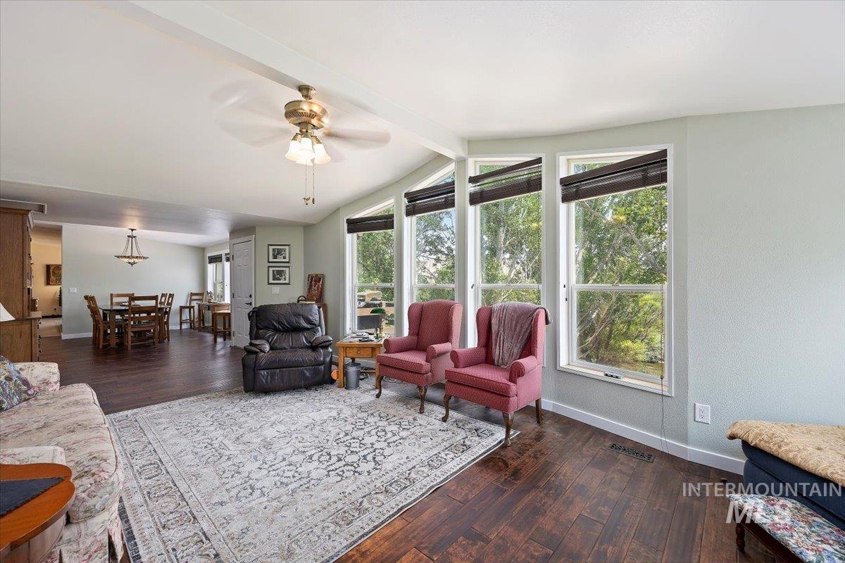 Living room featuring wood finished floors and ceiling fan