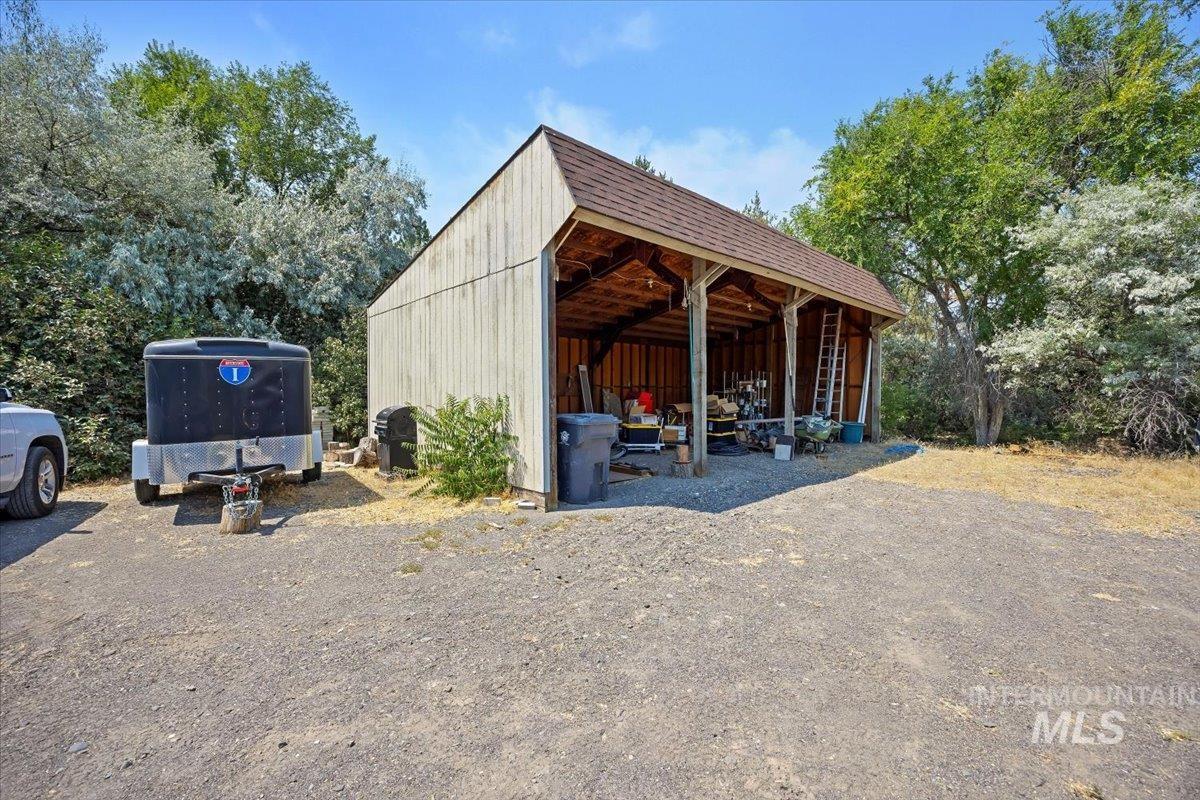 View of parking / parking lot with an outbuilding