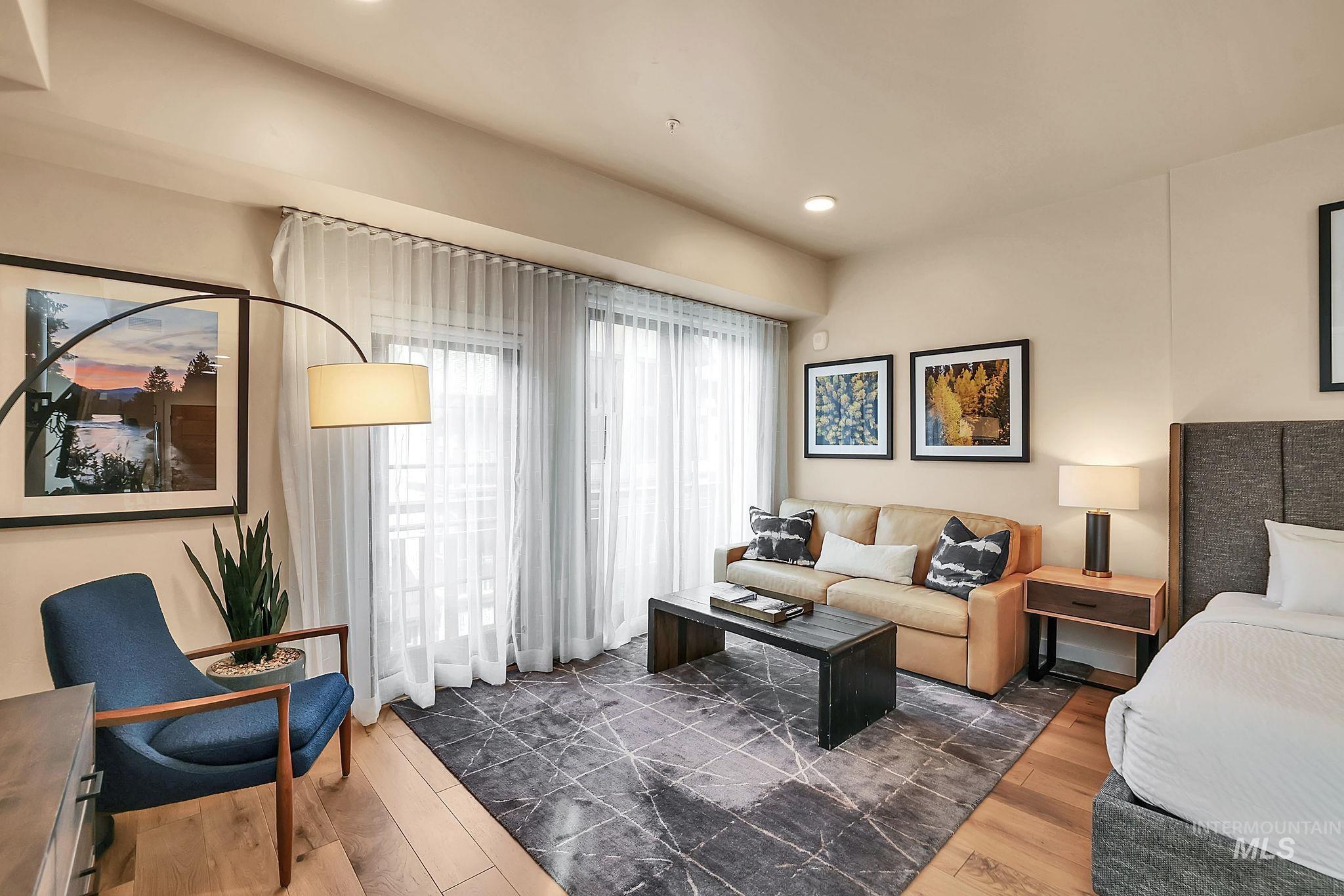 Living area with wood finished floors and recessed lighting