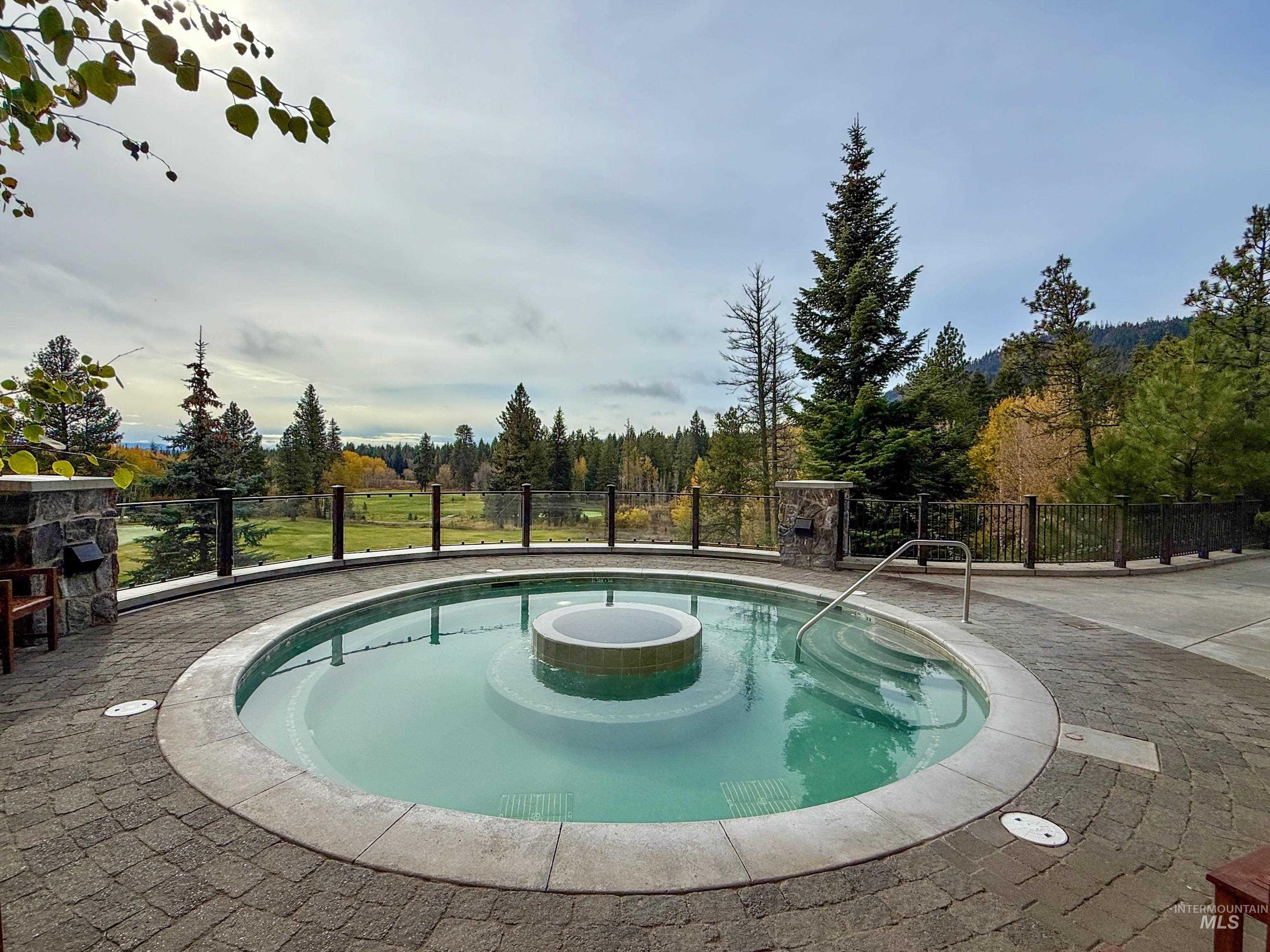 View of pool featuring a hot tub