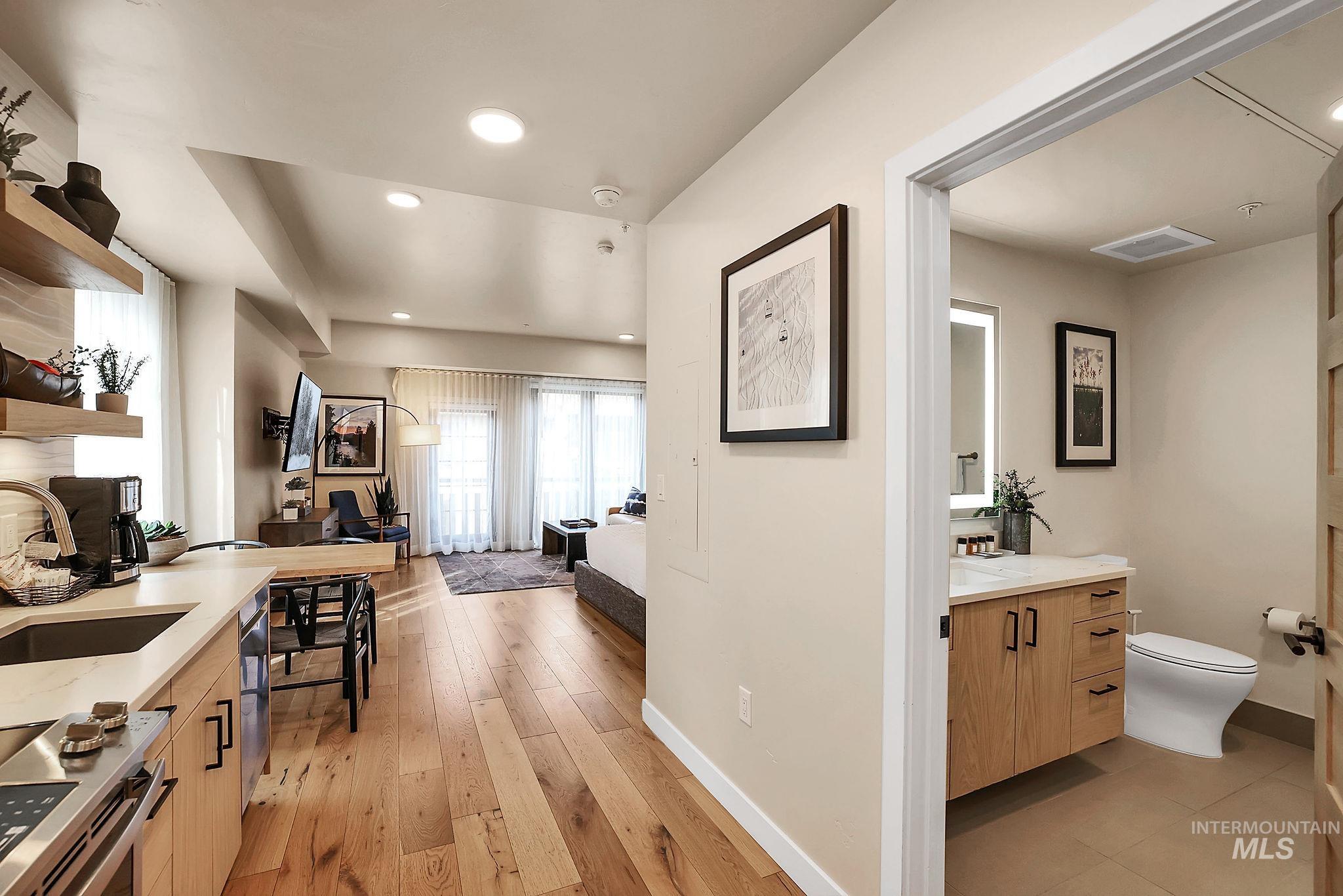 Bathroom featuring light wood-style floors, recessed lighting, and vanity