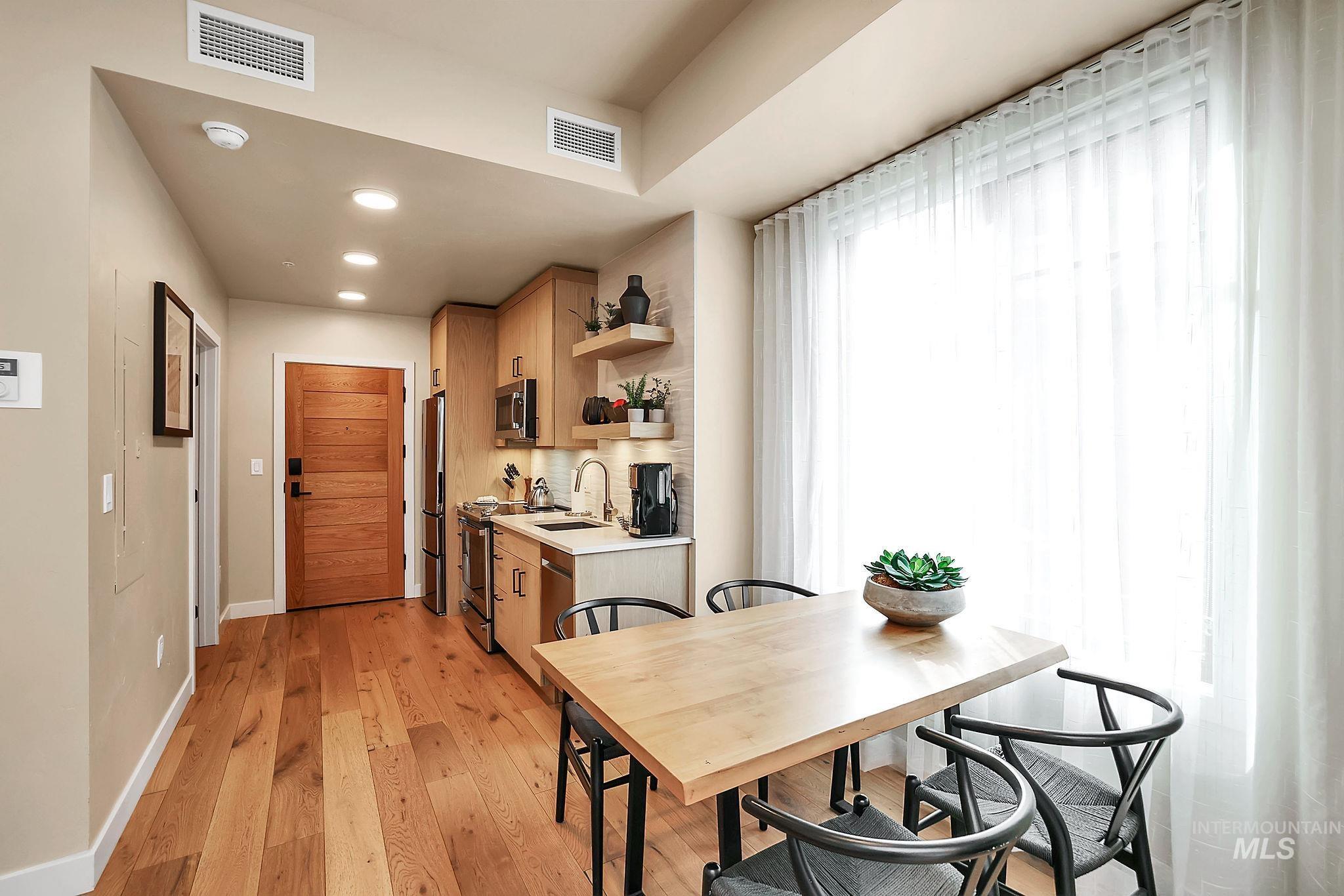 Dining area featuring light wood-style flooring and recessed lighting