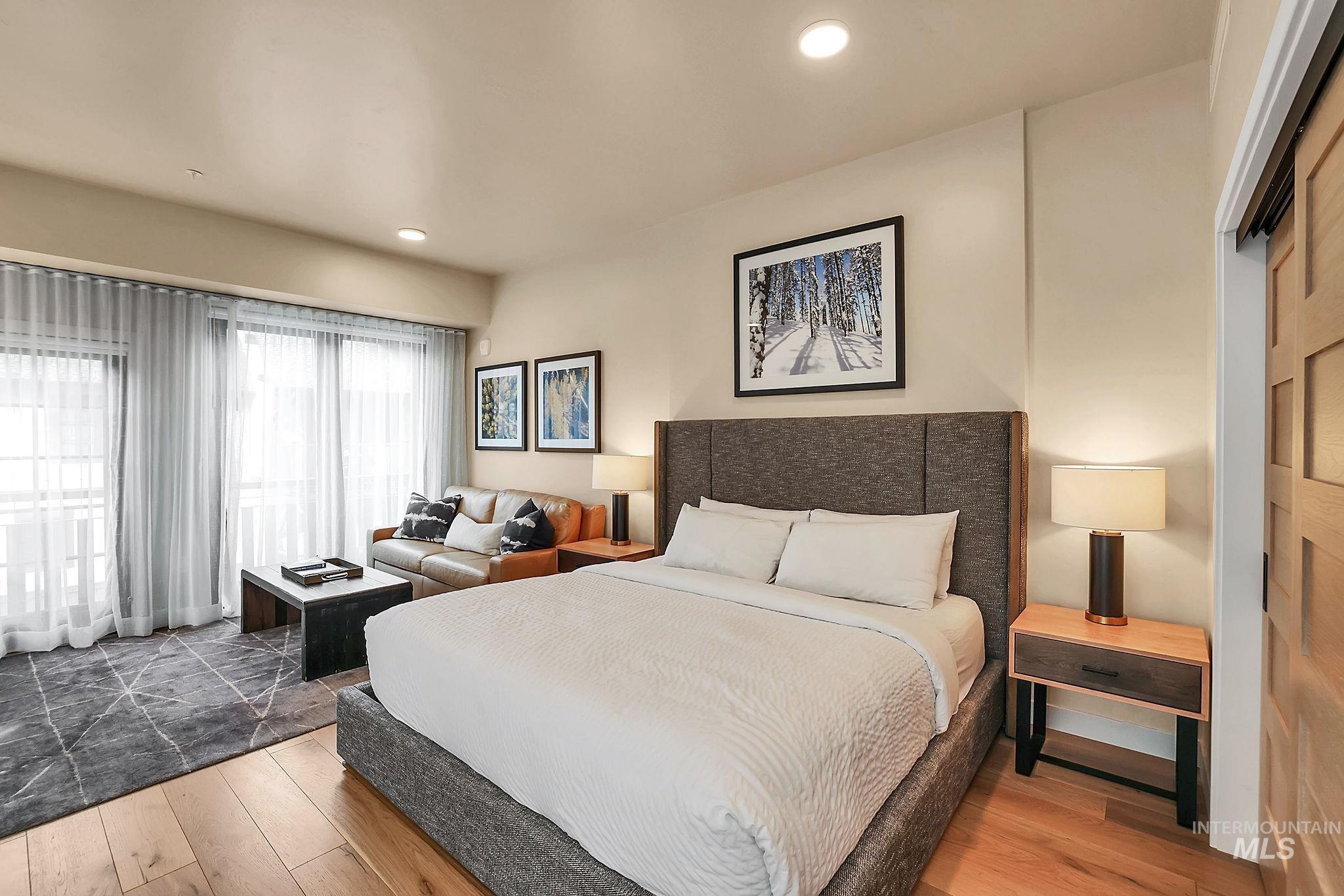Bedroom with wood finished floors and recessed lighting