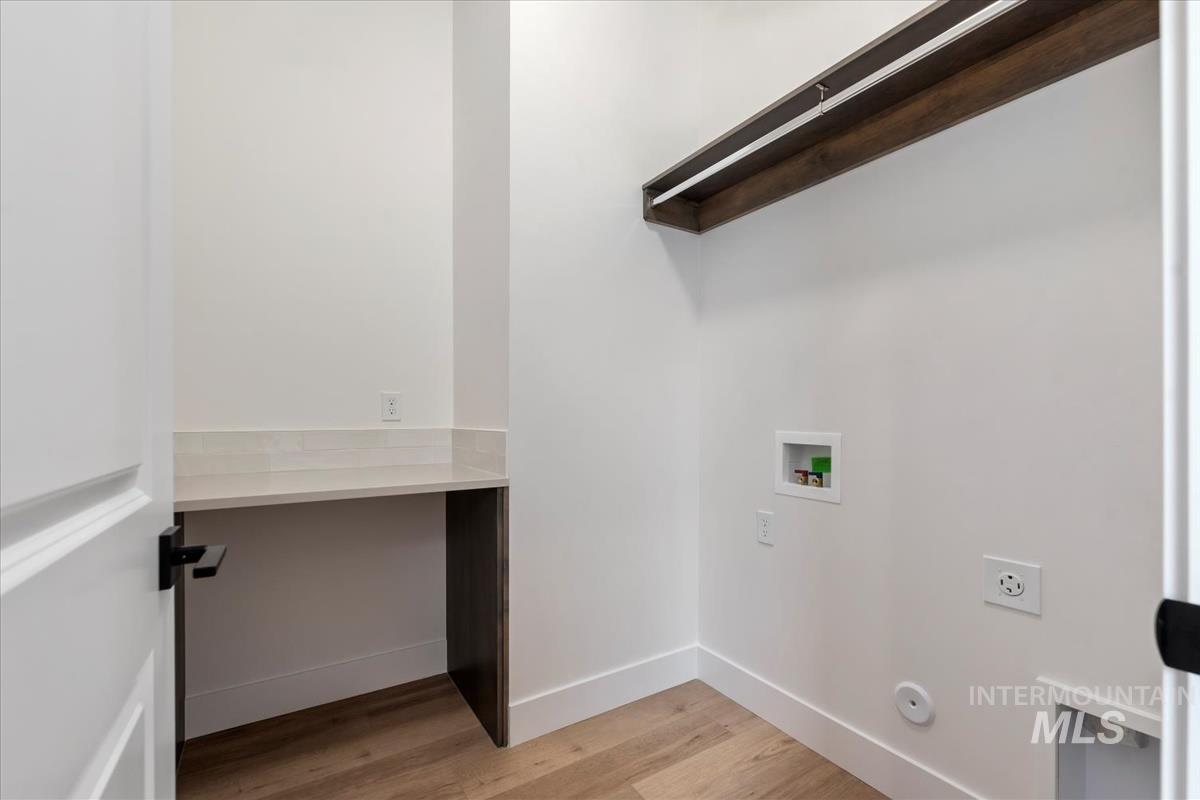 Laundry room featuring light wood-style flooring, washer hookup, and hookup for an electric dryer