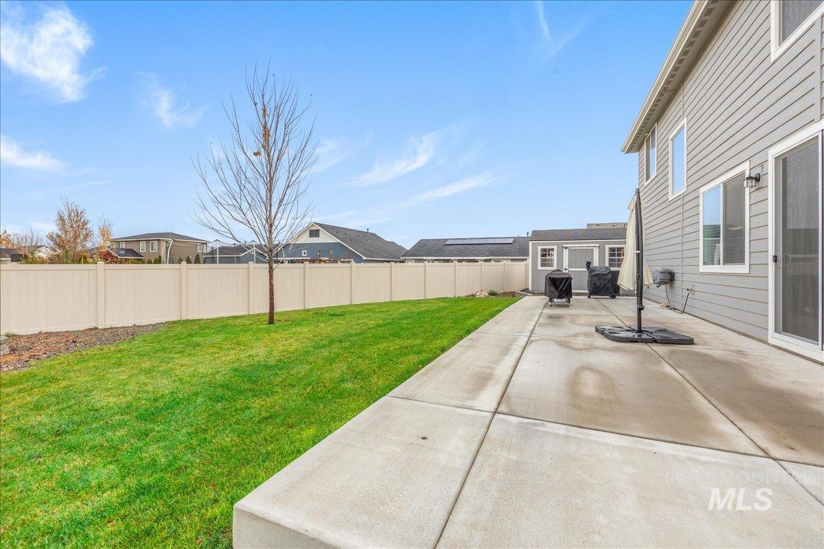 Fenced backyard with a patio area