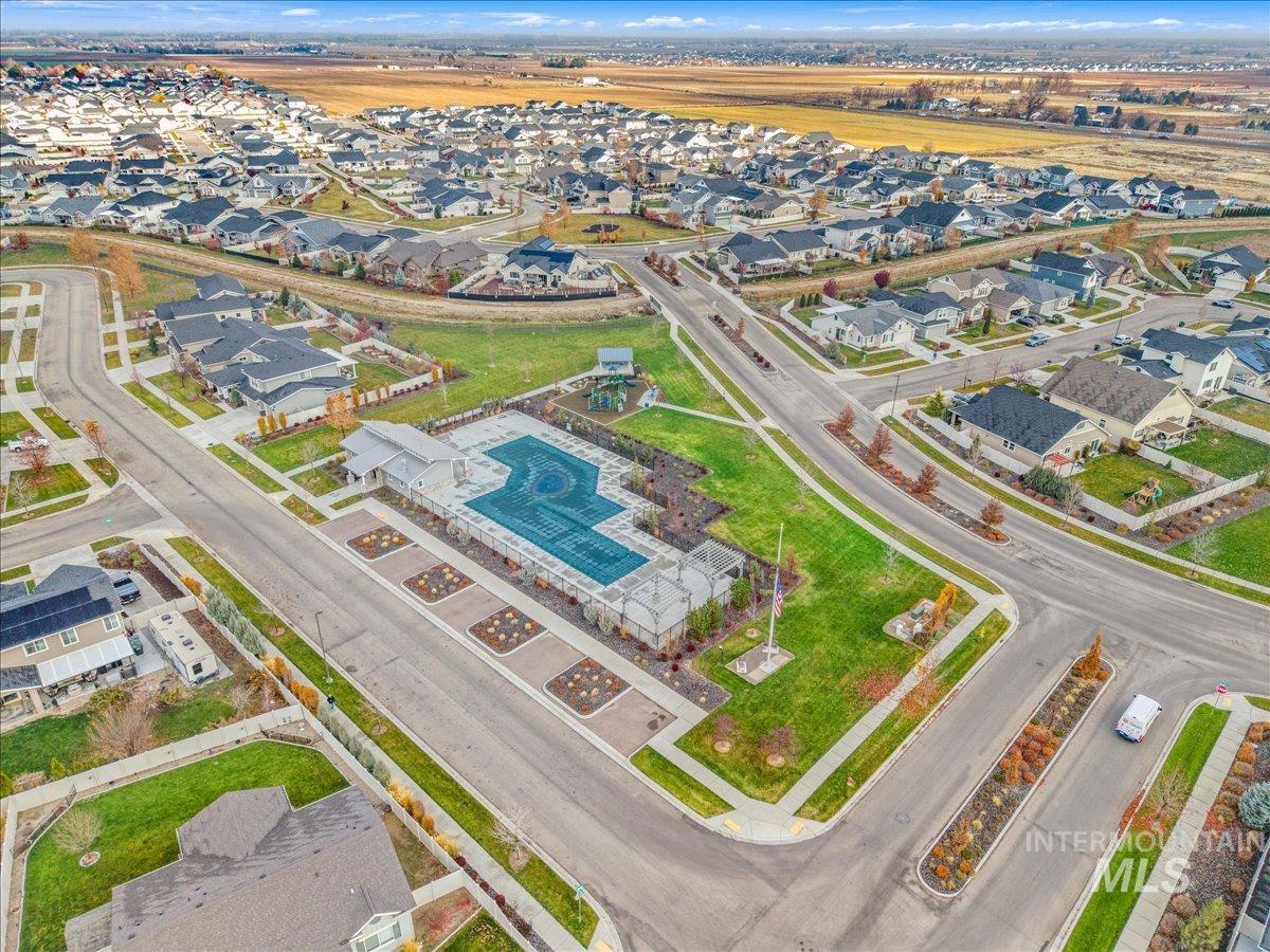 Aerial overview of property's location featuring nearby suburban area and a pool