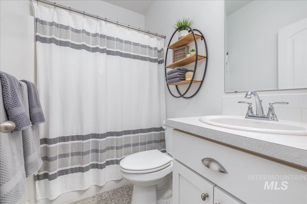 Full bathroom featuring vanity and a shower with shower curtain