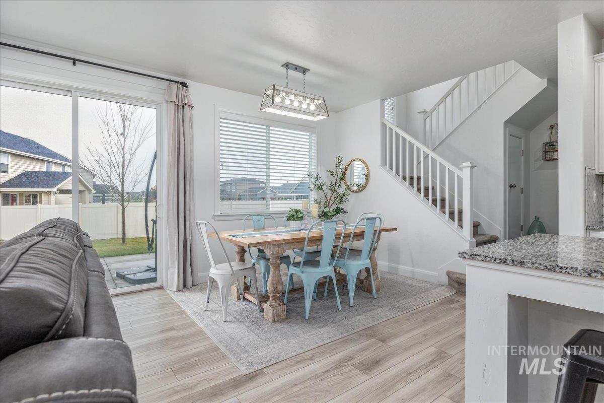 Dining space featuring stairway and light wood-style flooring