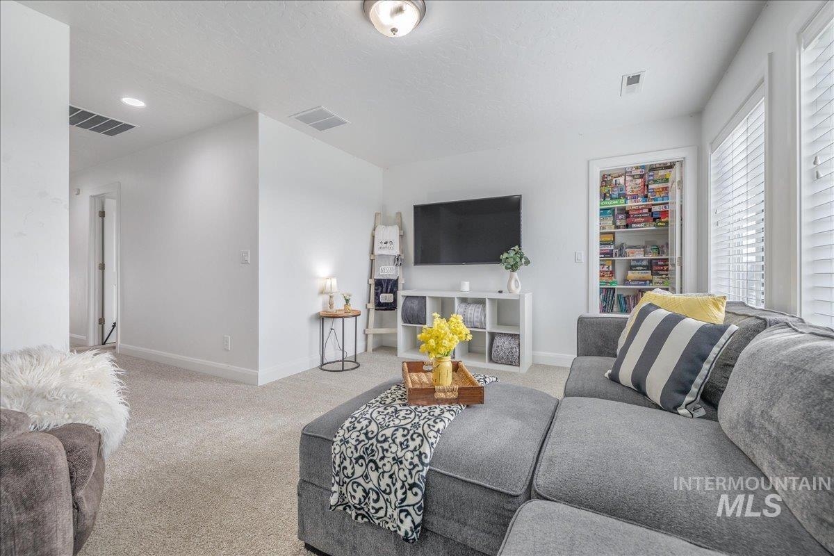 Living area with carpet and baseboards