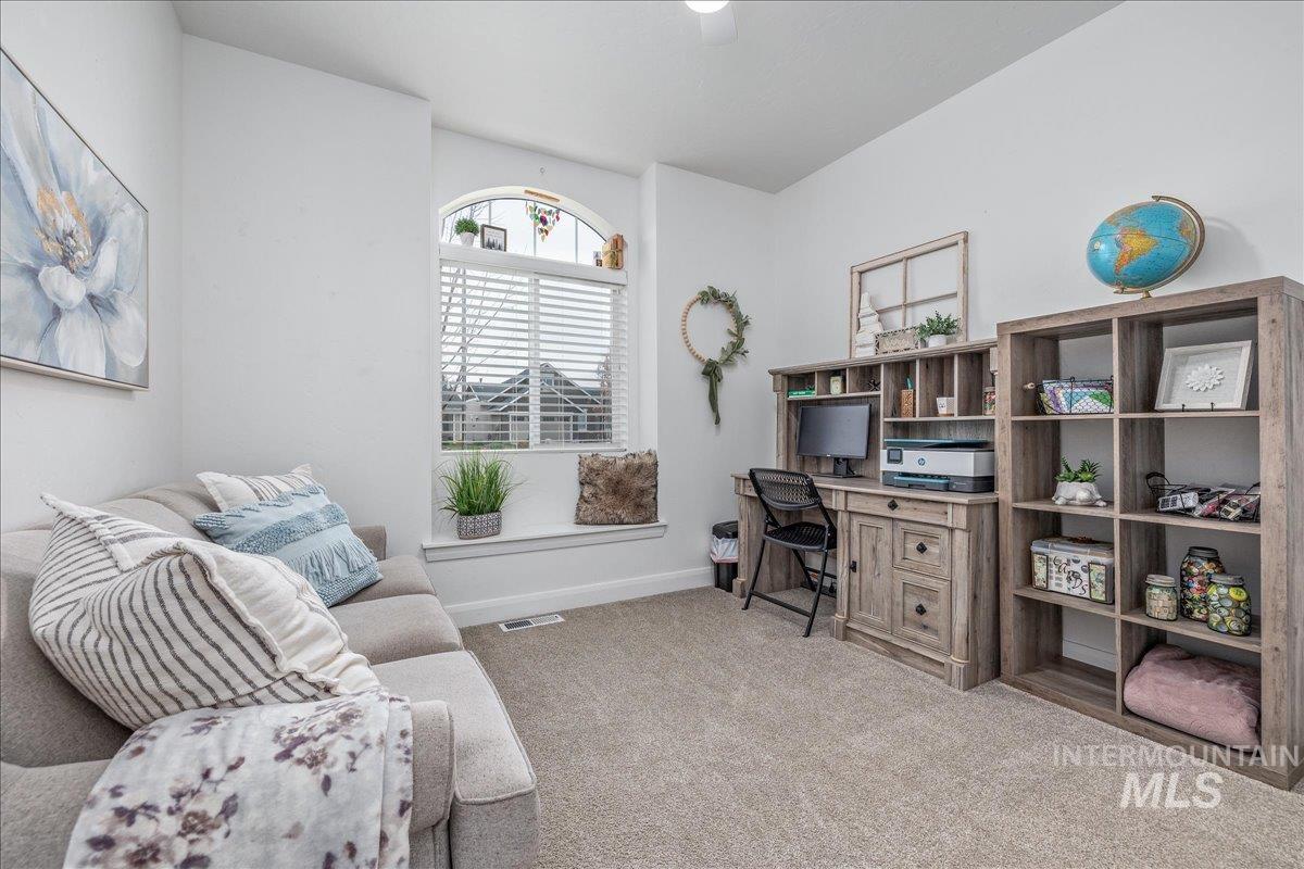 Office space featuring light carpet and baseboards