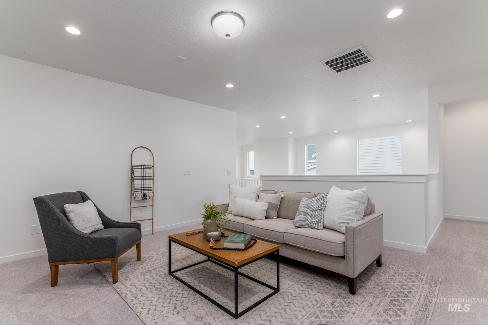 Living room featuring light carpet and recessed lighting