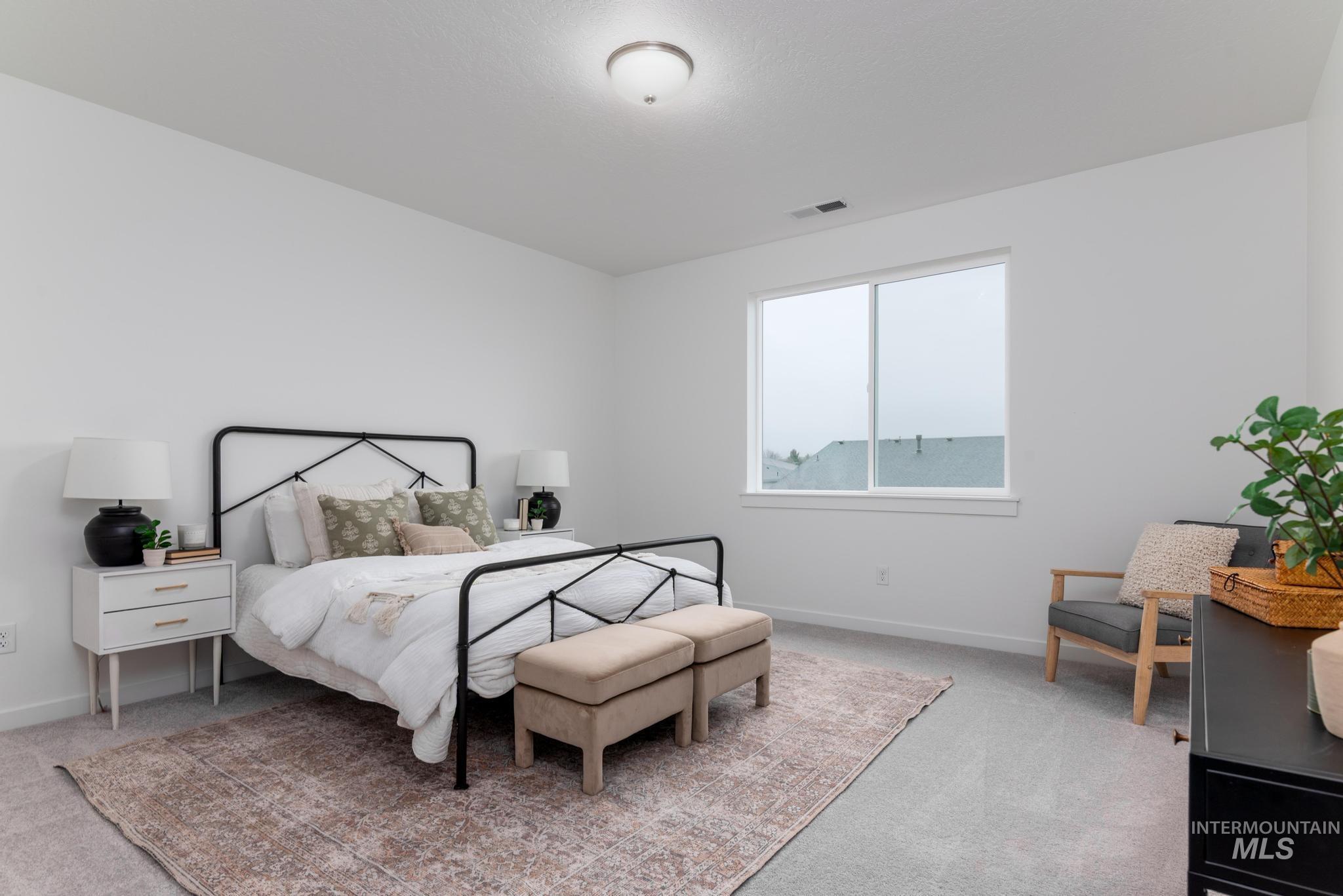 Bedroom featuring baseboards and light colored carpet