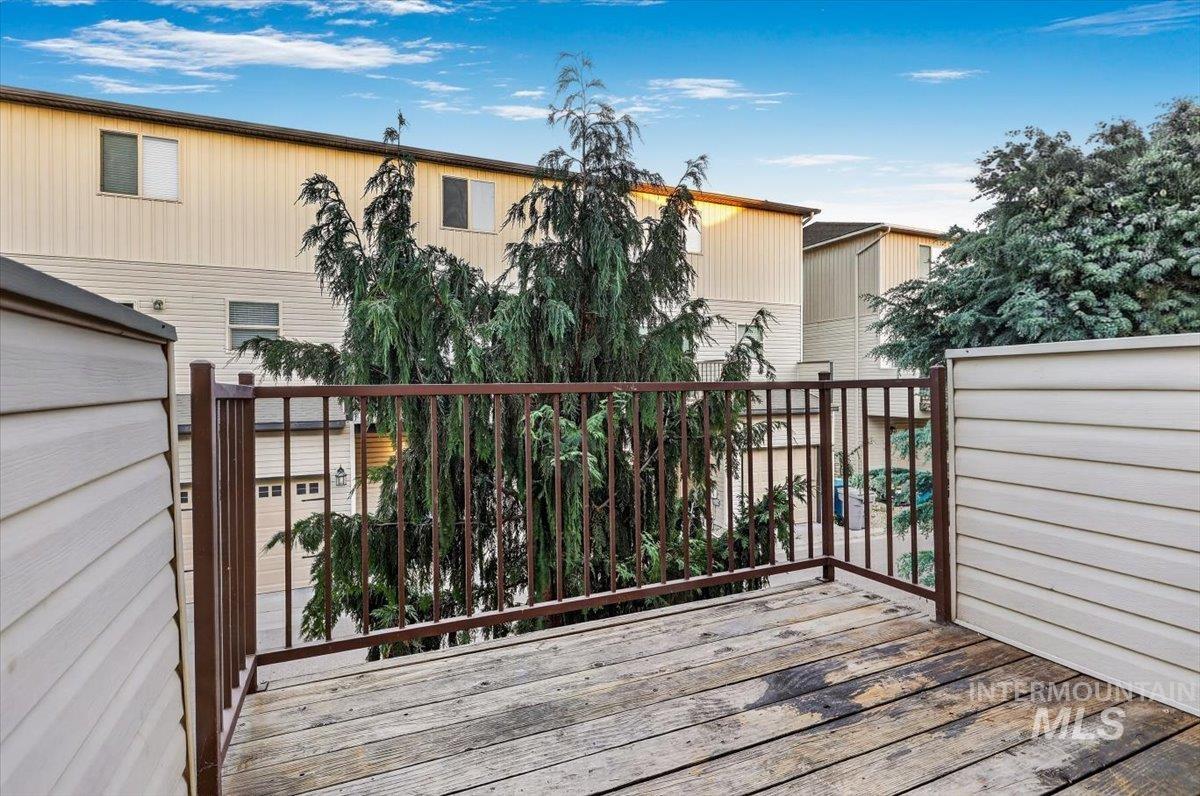 Outdoor deck with wood-finish flooring and metal railing