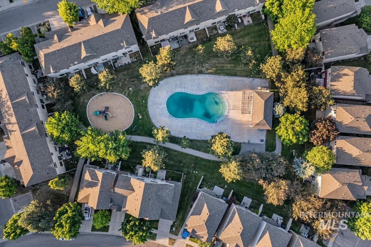 Centrally located community pool with surrounding paved deck