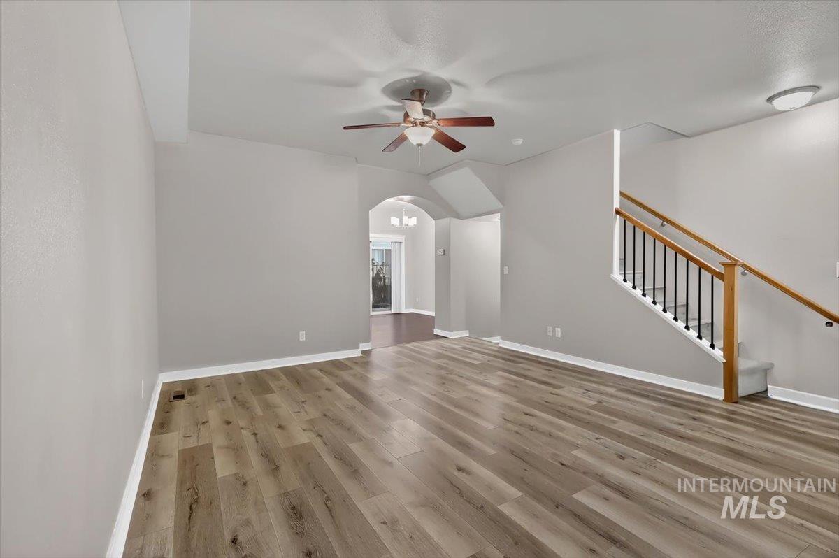 Spacious interior featuring wood-finish flooring, light gray walls, and white baseboards
