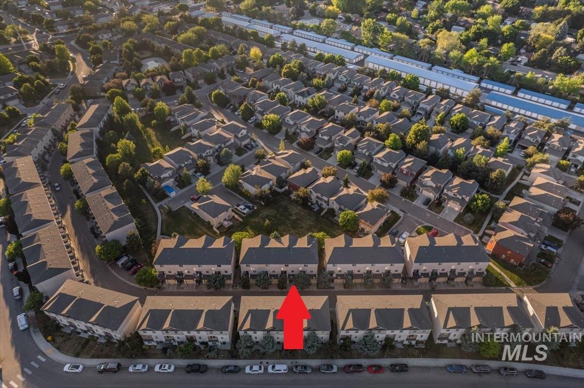 Aerial perspective of a multi-unit residential development featuring uniform townhome-style architecture