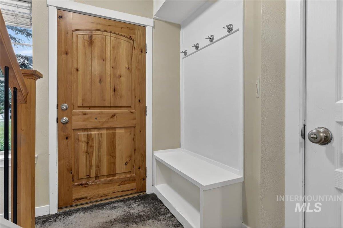 Natural wood-finish entry door with panel detailing