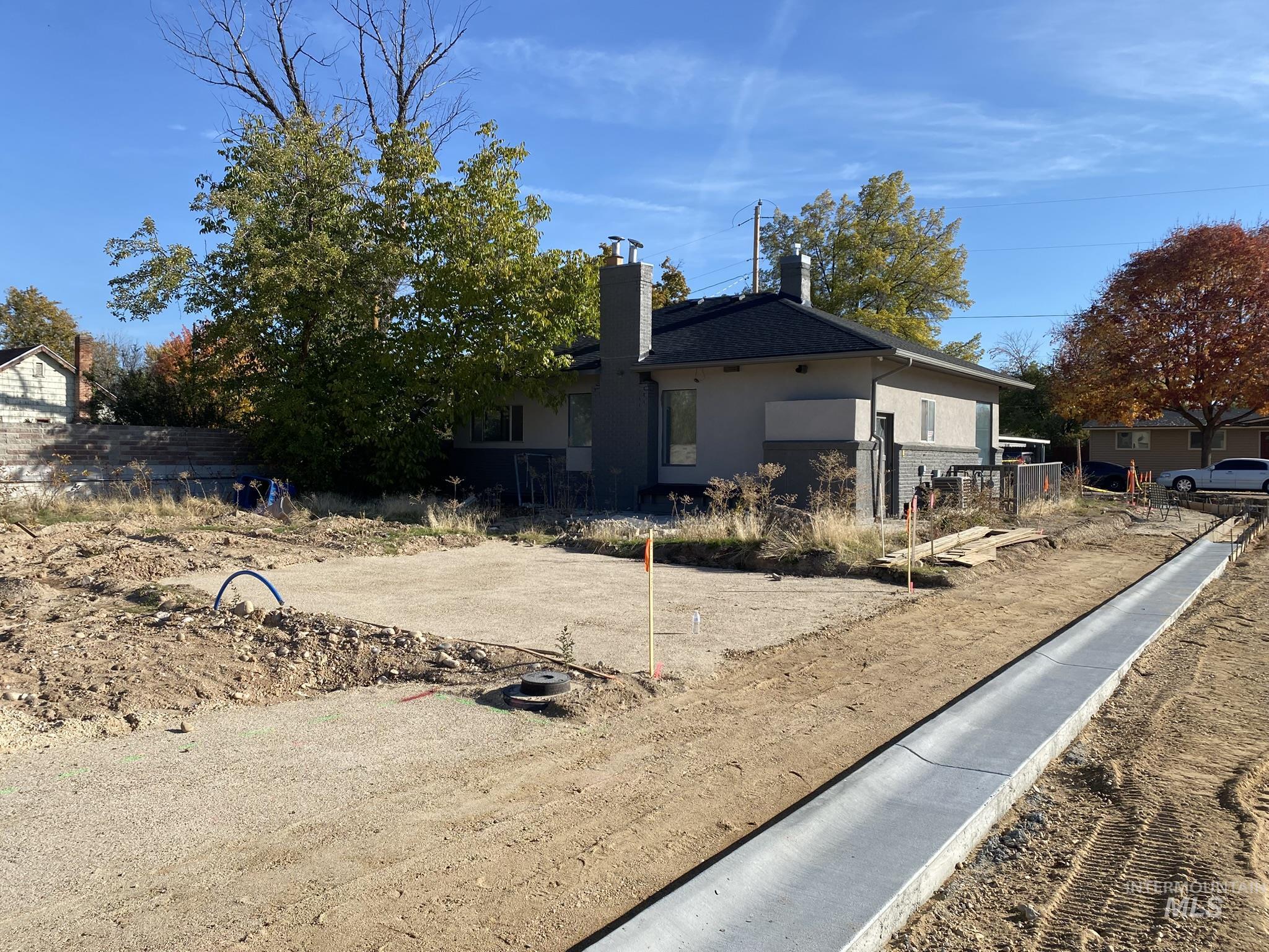 Rear view of house with a chimney and stucco siding
