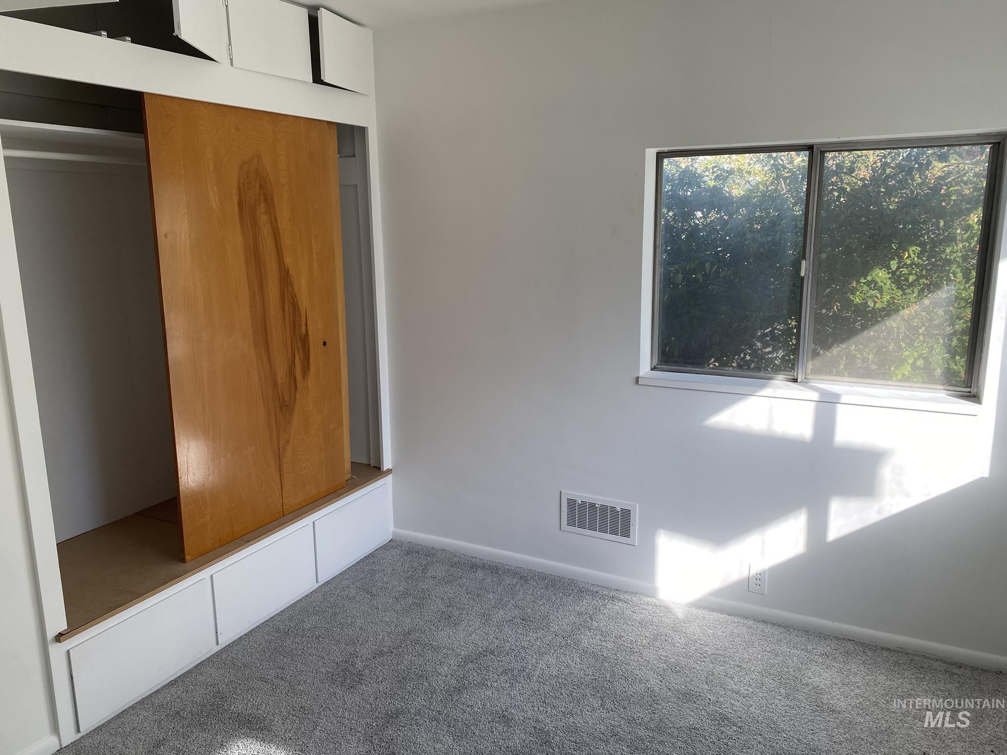 Unfurnished bedroom featuring carpet flooring and a closet