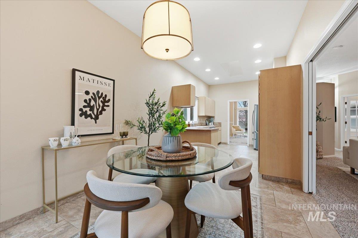 Dining space featuring recessed lighting and stone tile floors