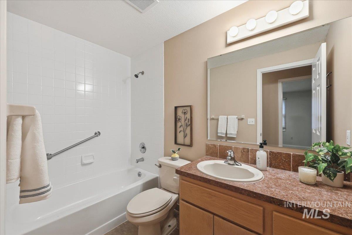 Full bath with vanity and bathtub / shower combination