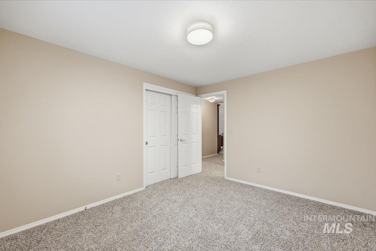 Unfurnished bedroom featuring carpet floors and a closet