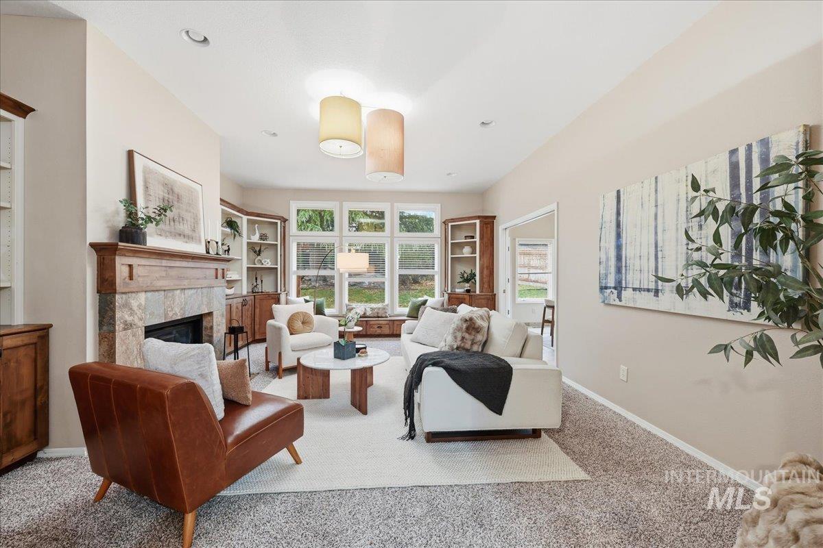 Carpeted living area featuring a fireplace and built in features