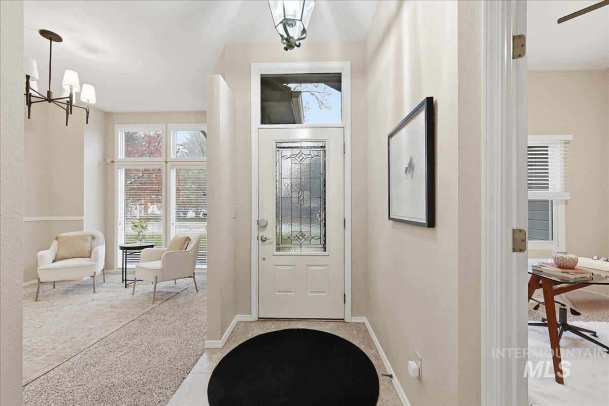 Entryway featuring a chandelier and light colored carpet