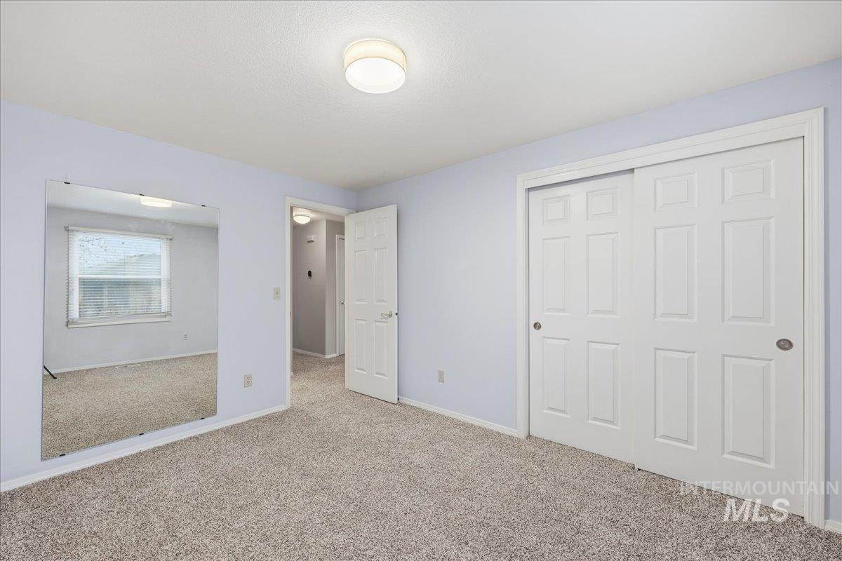 Unfurnished bedroom featuring carpet and a closet