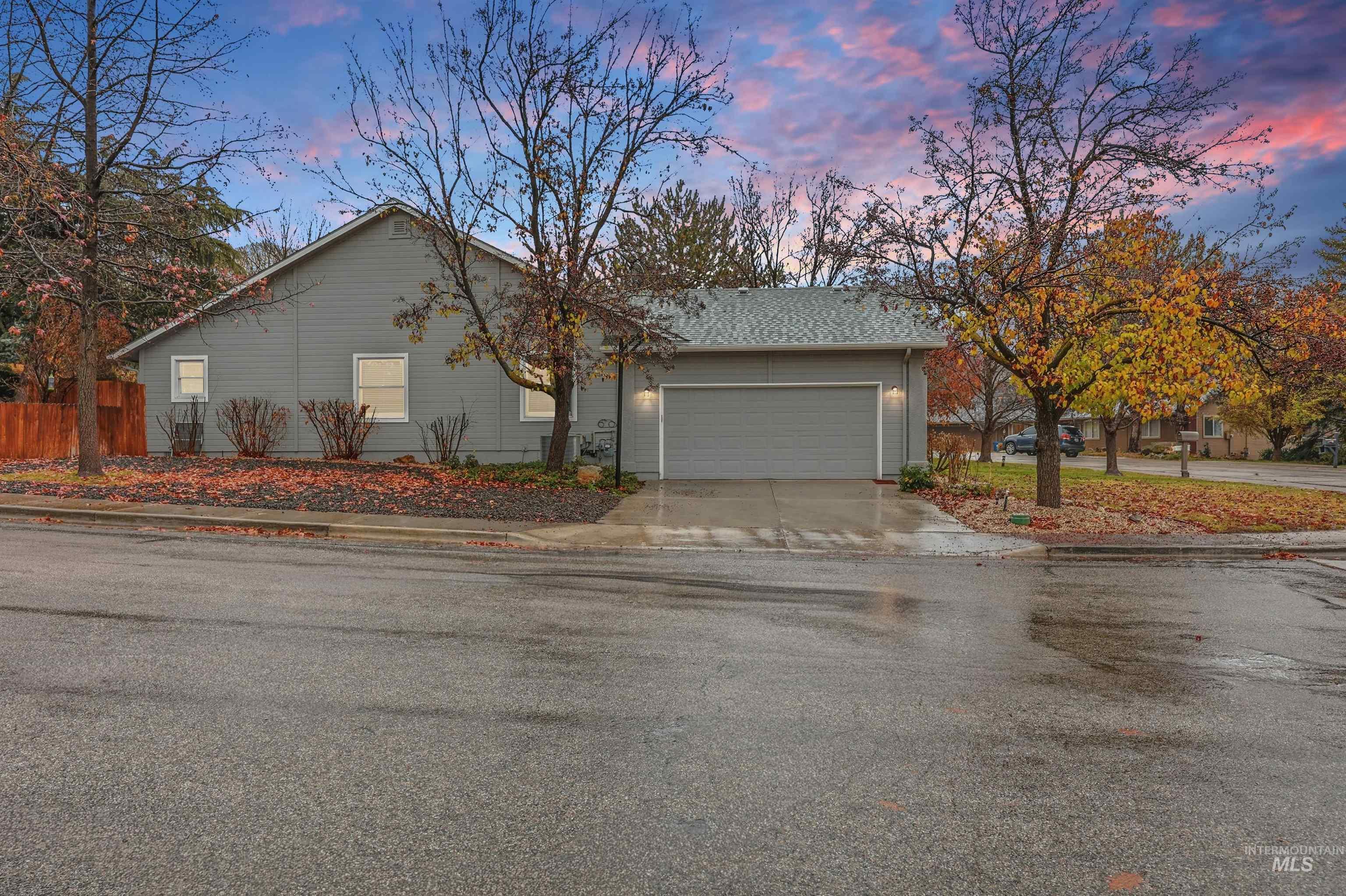 Property exterior at dusk with concrete driveway and a garage