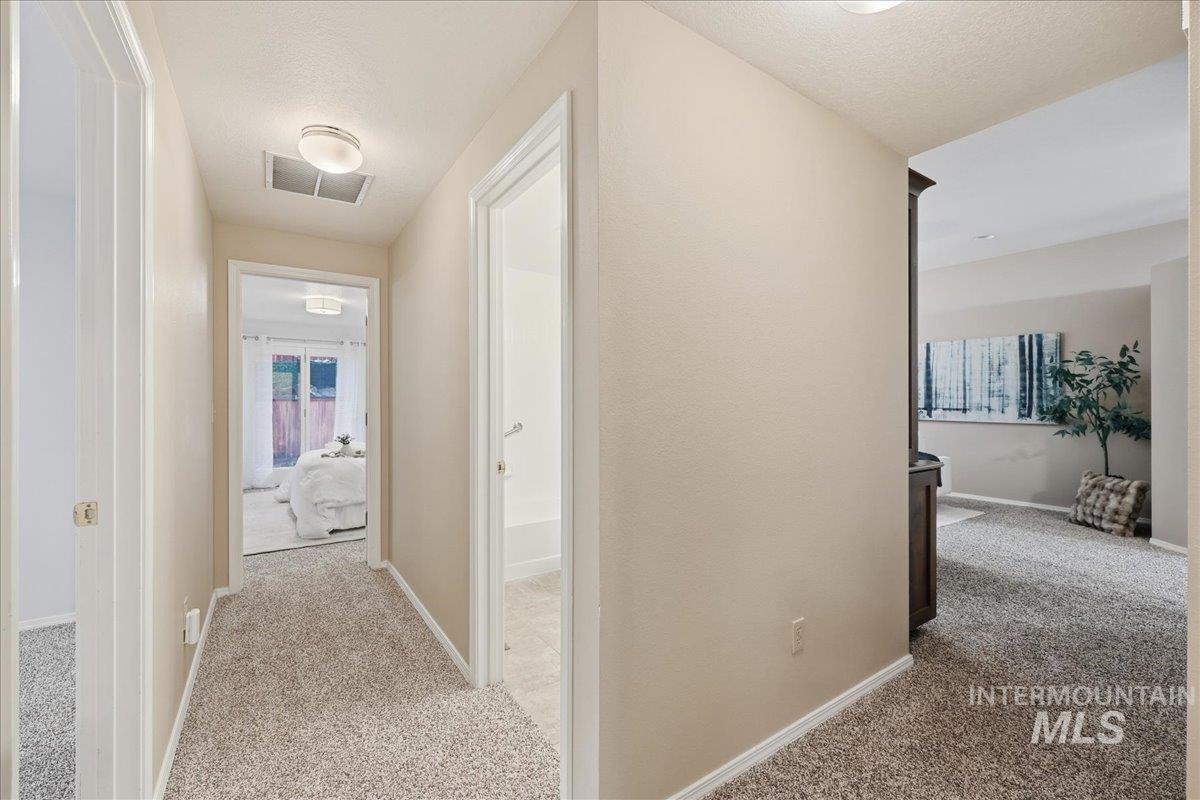 Hallway with carpet flooring