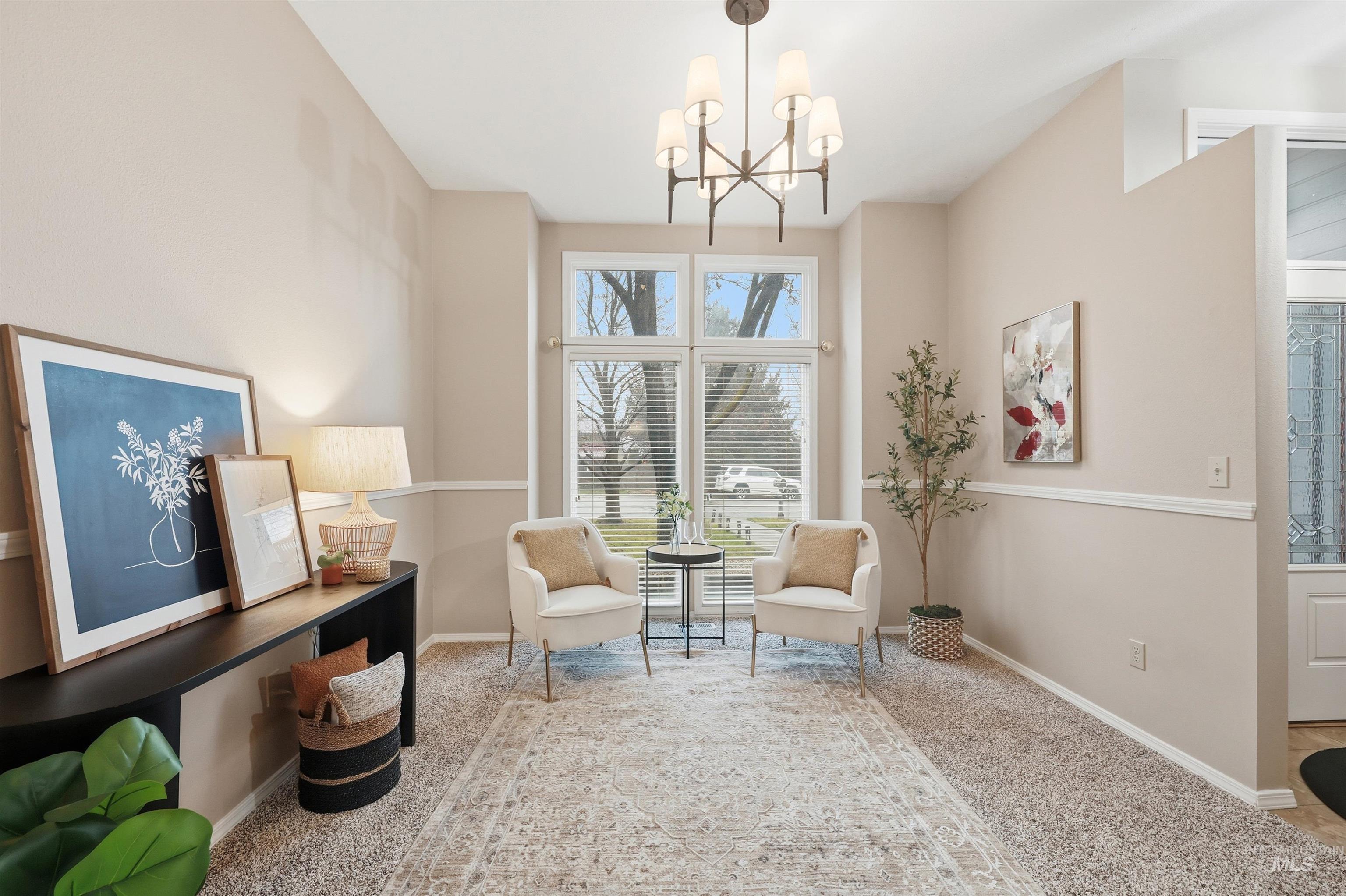 Sitting room featuring carpet flooring and a chandelier