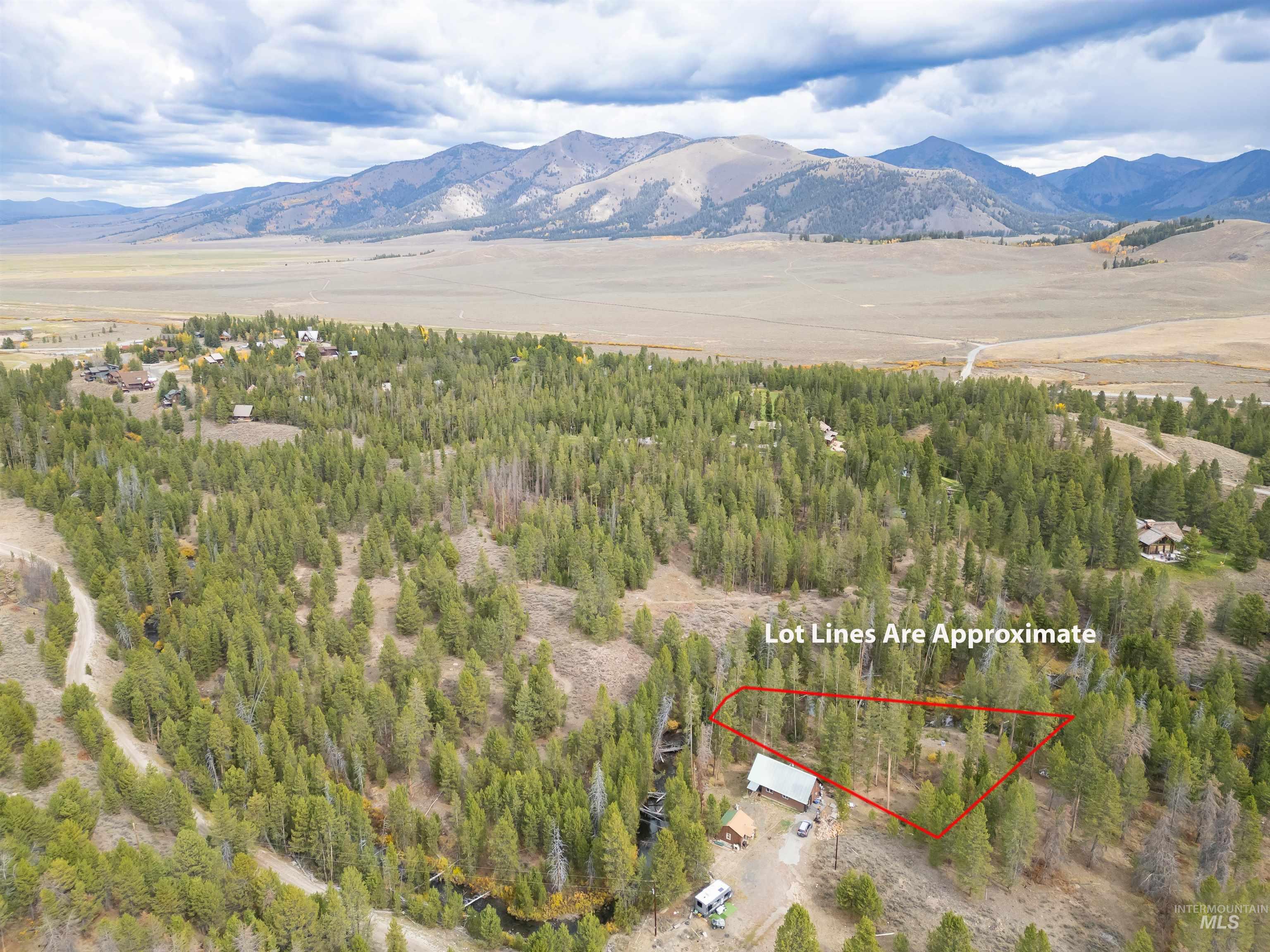 Aerial overview of property's location featuring mountains and property parcel outlined