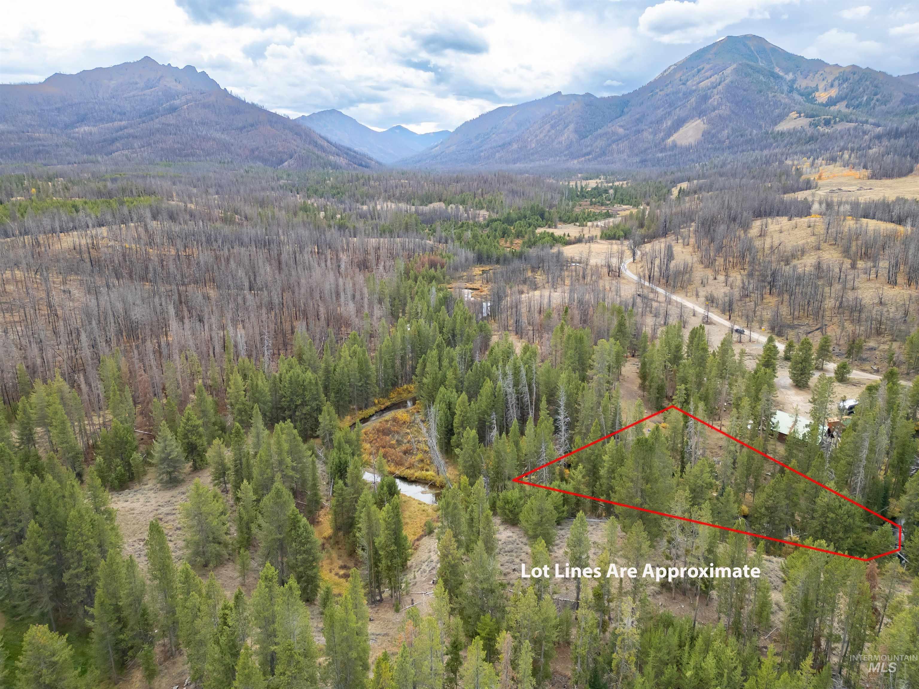 Aerial overview of property's location with mountains and property parcel outlined