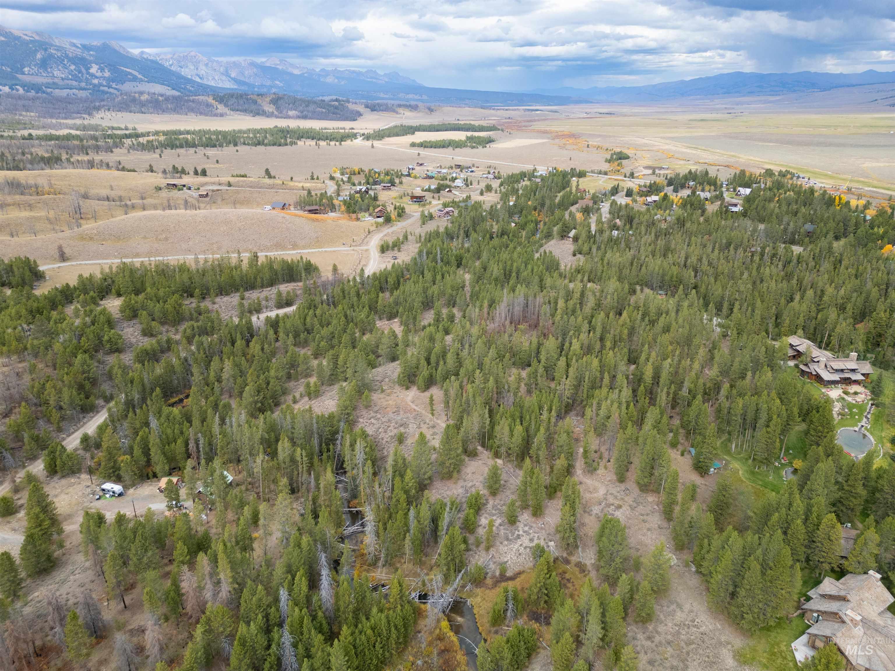 Aerial view of property and surrounding area with a mountain backdrop