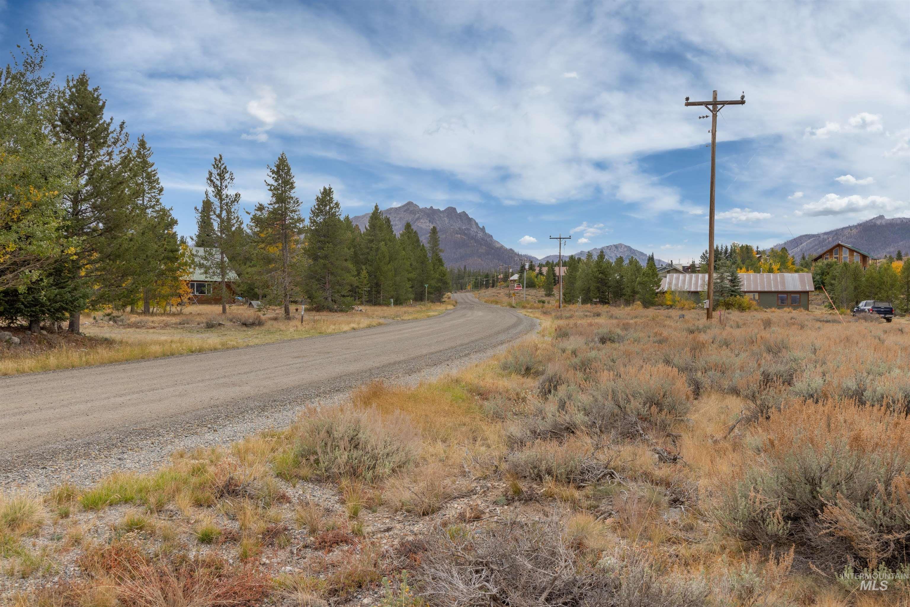 View of dirt / gravel road featuring a mountain view