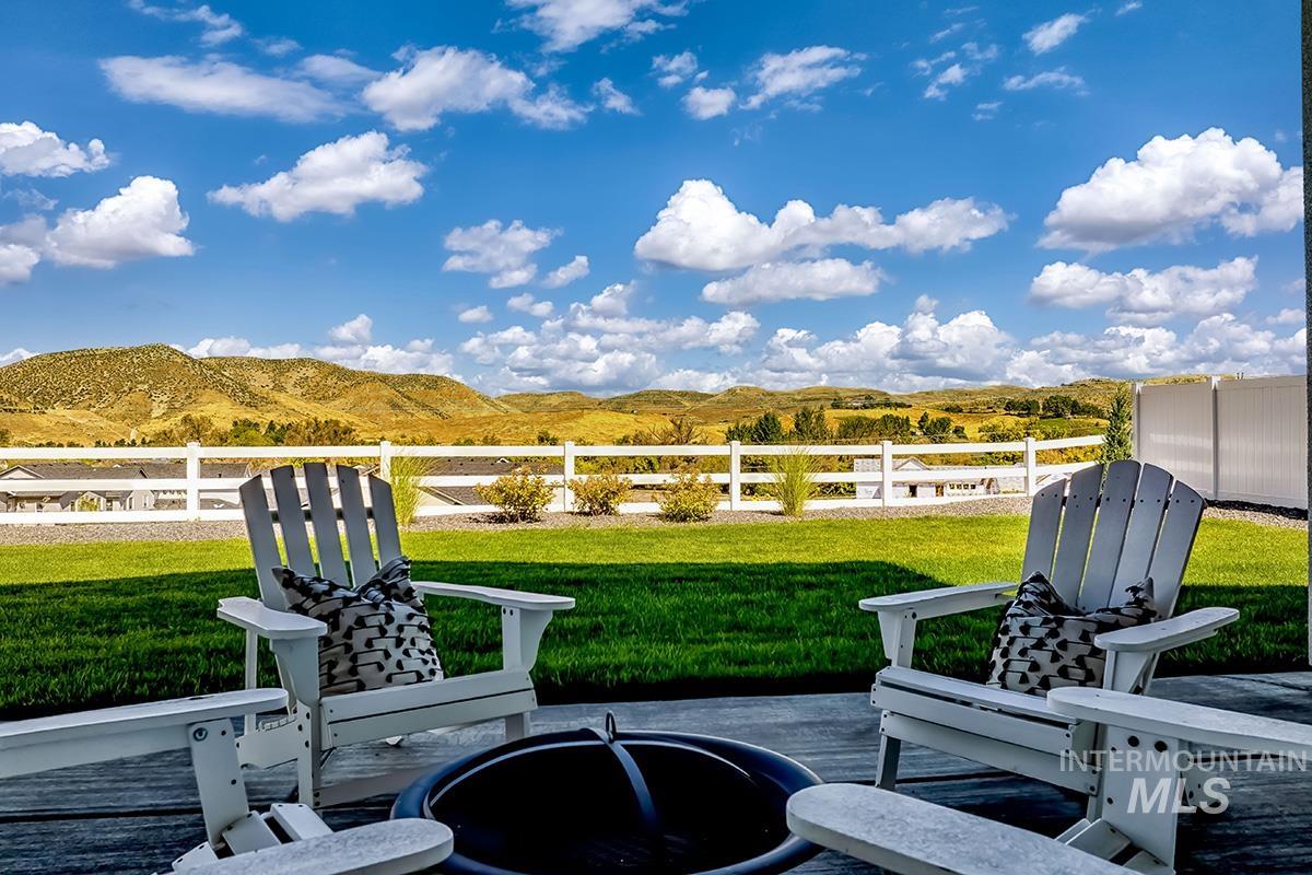 View of patio / terrace with a mountain view and an outdoor fire pit