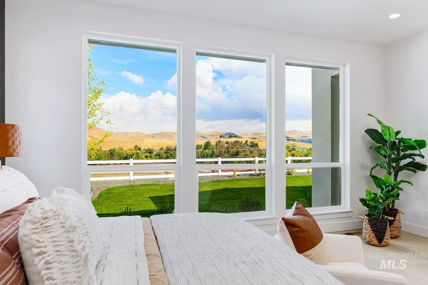 Bedroom with a mountain view, wood finished floors, and recessed lighting