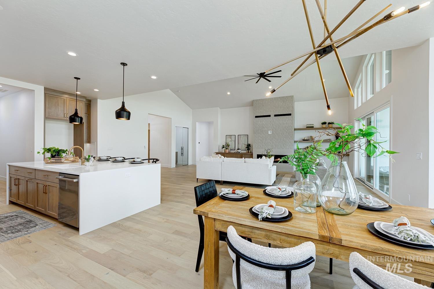 Dining area with light wood-type flooring, ceiling fan, recessed lighting, and high vaulted ceiling