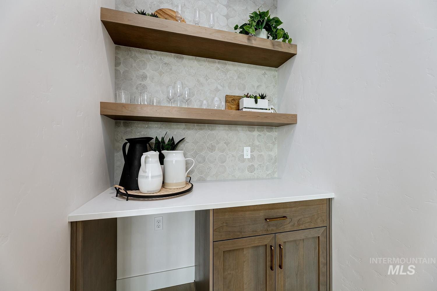 Bar with decorative backsplash, brown cabinetry, and open shelves