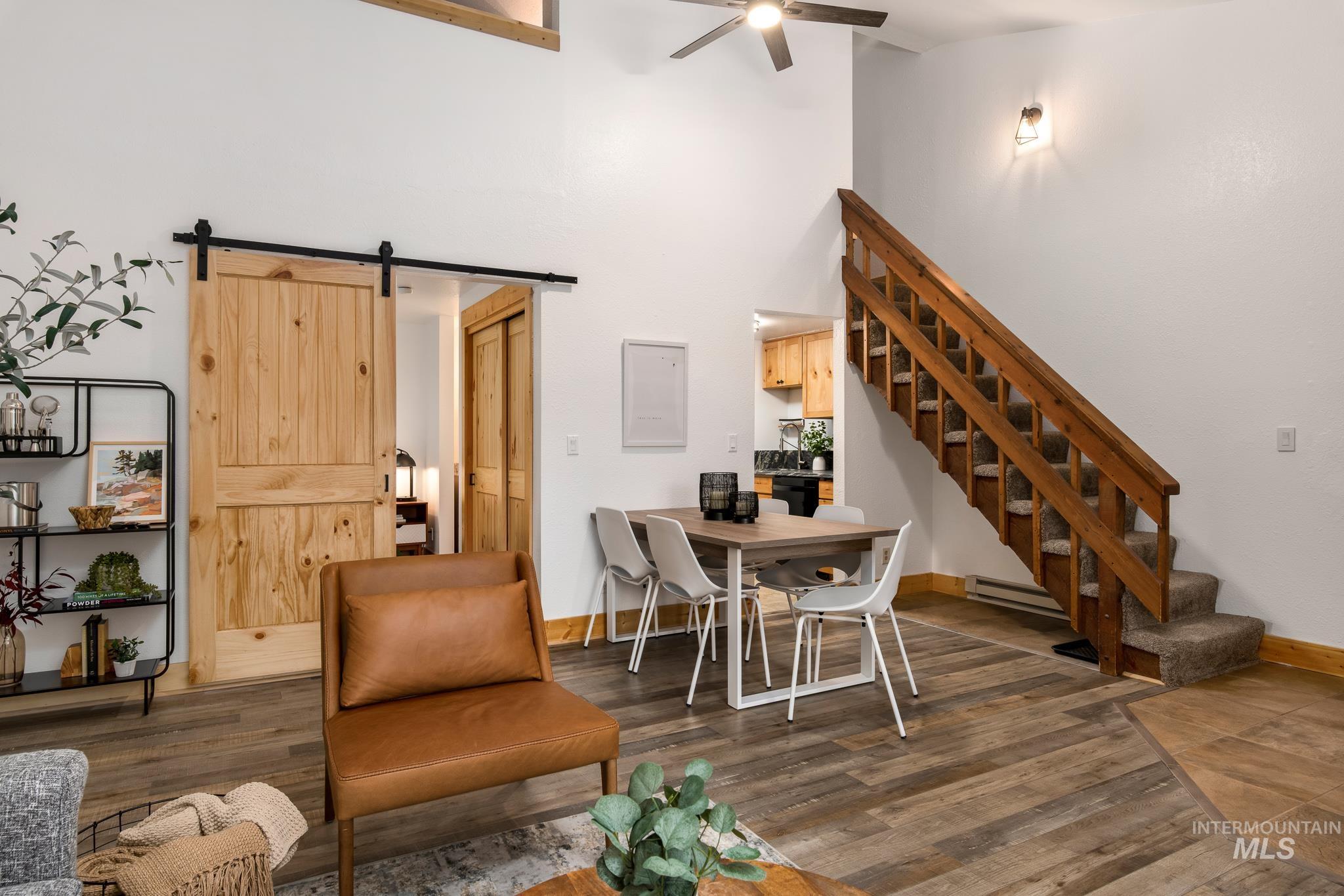 Open-concept living space with vaulted ceilings and wood-finish flooring