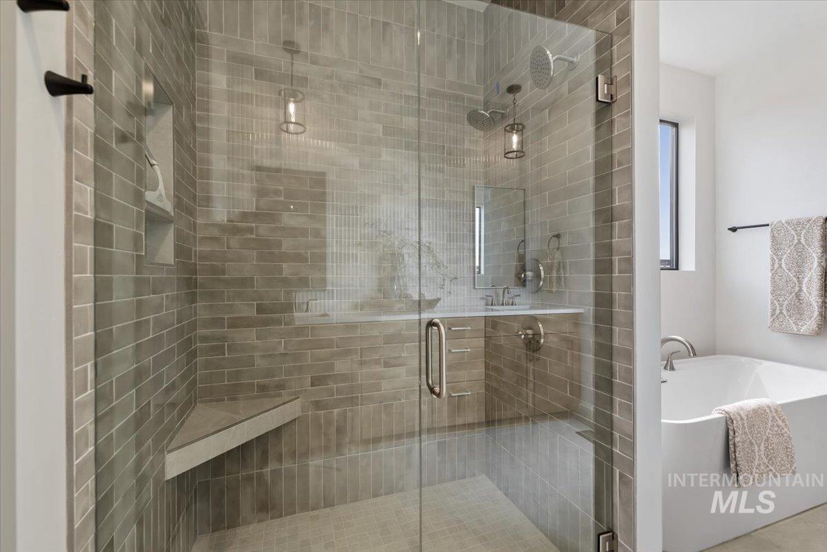 Full bathroom featuring a soaking tub and a stall shower