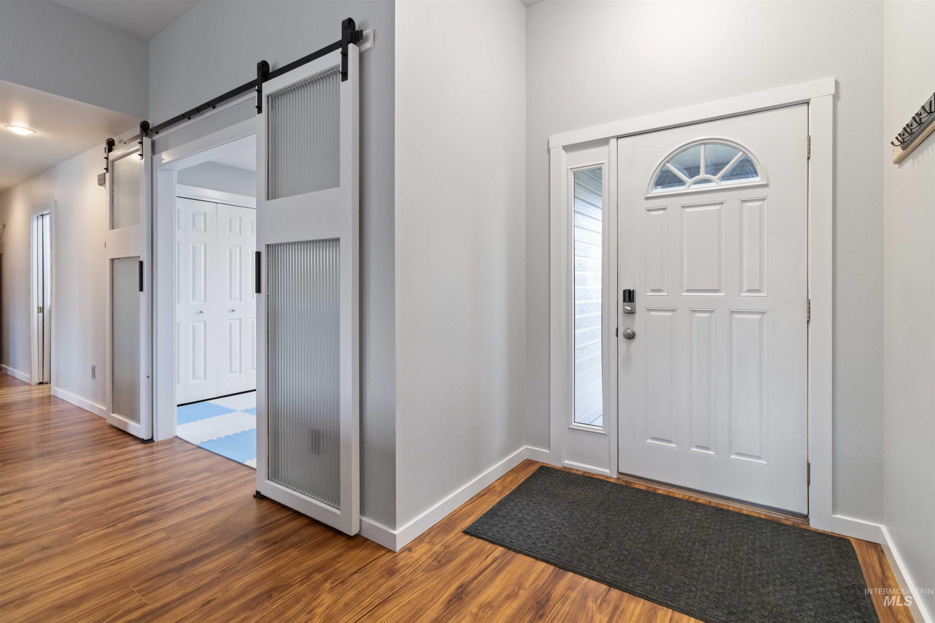 Entryway featuring wood finished floors and a barn door
