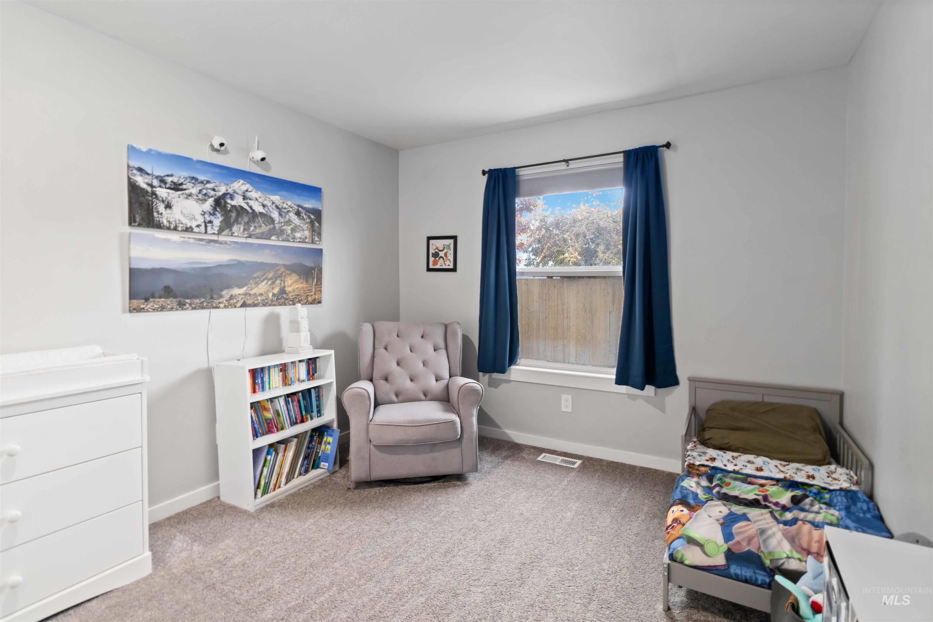 Carpeted bedroom with baseboards