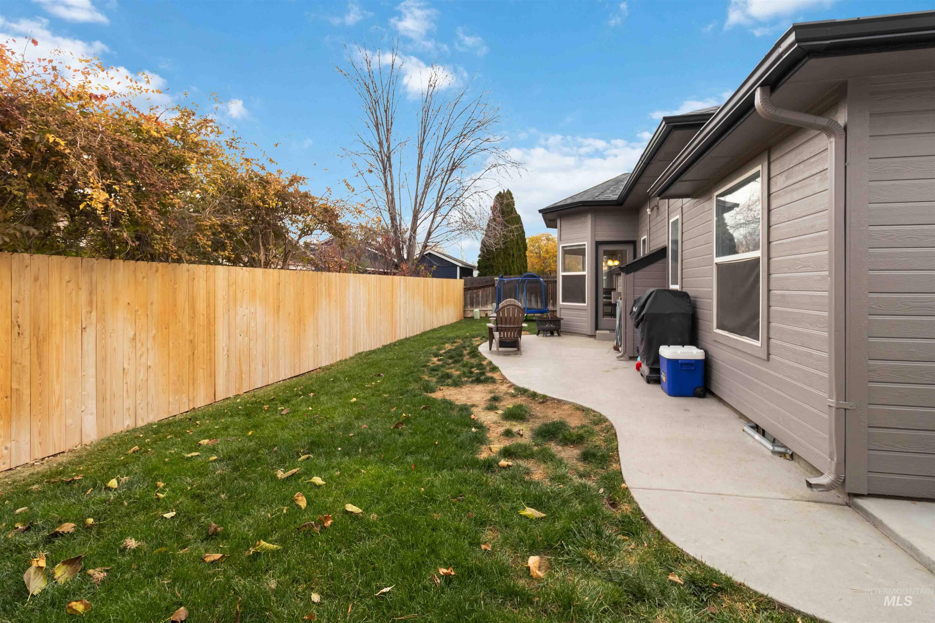 Fenced backyard with a patio
