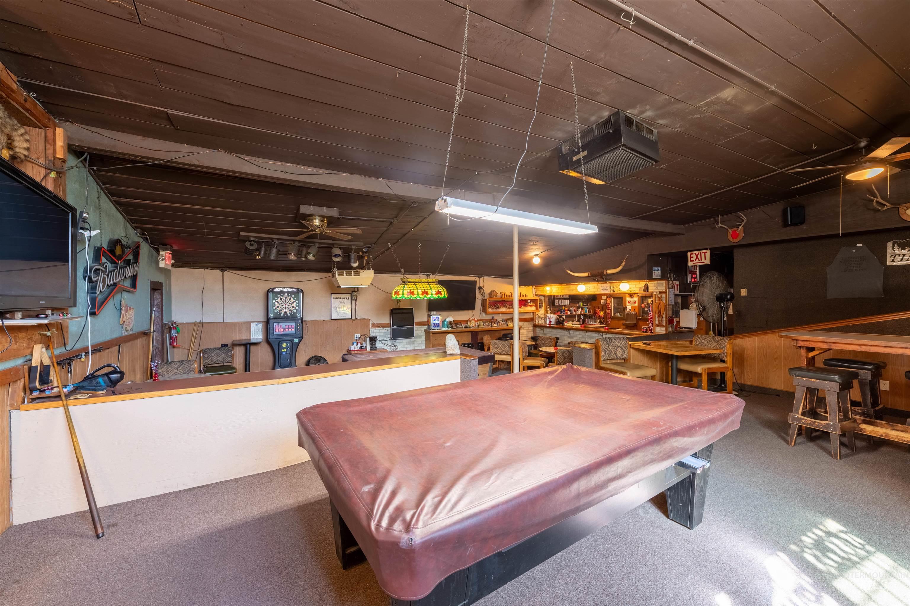 Playroom featuring billiards and wood walls