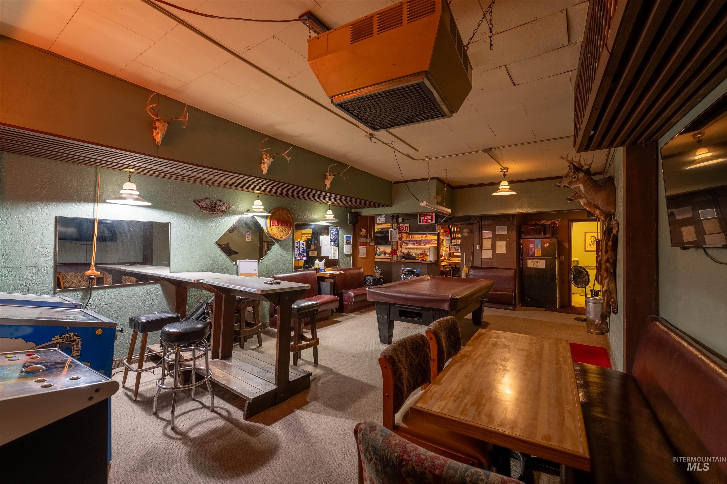 Playroom with a heating unit, light colored carpet, and billiards