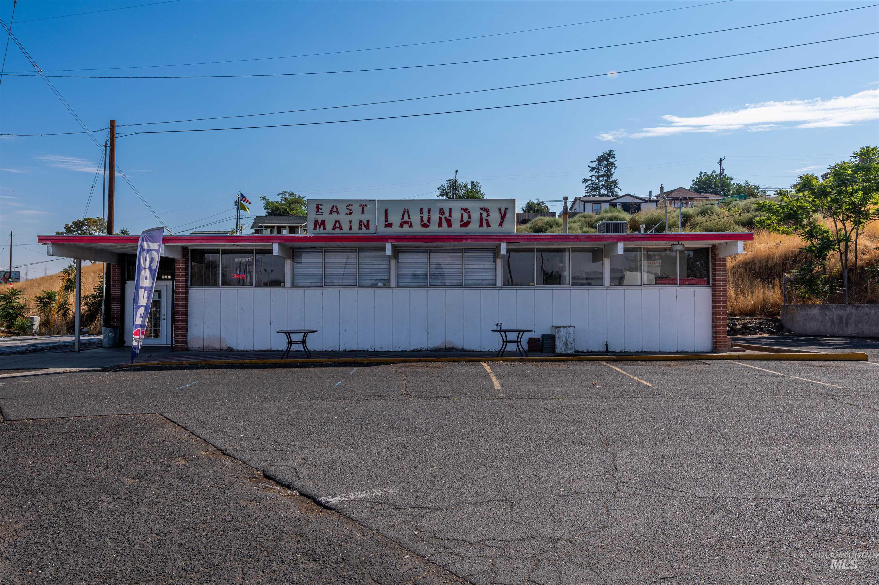 View of building exterior featuring uncovered parking